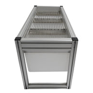 Side view of a small stationary harvest sorting system with aluminum frame, metal grates, and white collection tray.