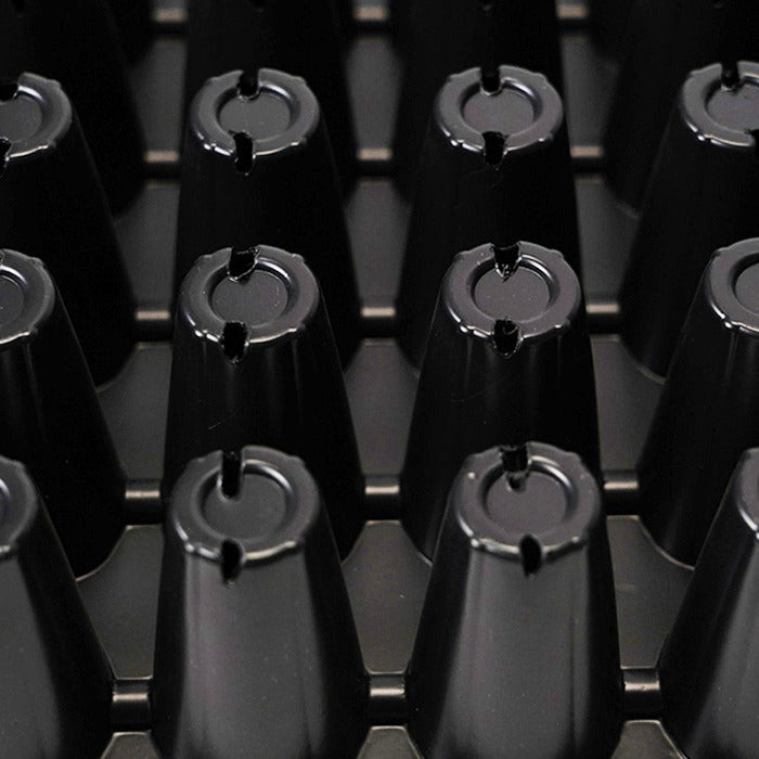 Black 72-cell seedling tray with conical cells, close-up view, showing the circular openings with notches.