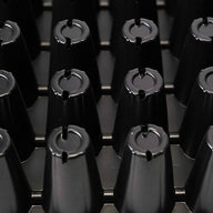 Black 72-cell seedling tray with conical cells, close-up view, showing the circular openings with notches.