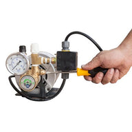 Hand adjusts pressure switch on a Hydro-Tech booster pump with a screwdriver.