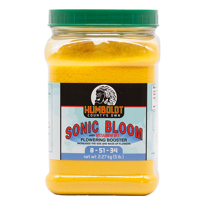 Humboldt County's Own Sonic Bloom flowering booster in a clear plastic jug with a green lid, containing yellow powder.