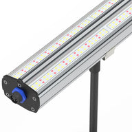 Close-up of a HortiBloom LED grow light: silver fixture with red/yellow chips, blue connector, on a black pole.