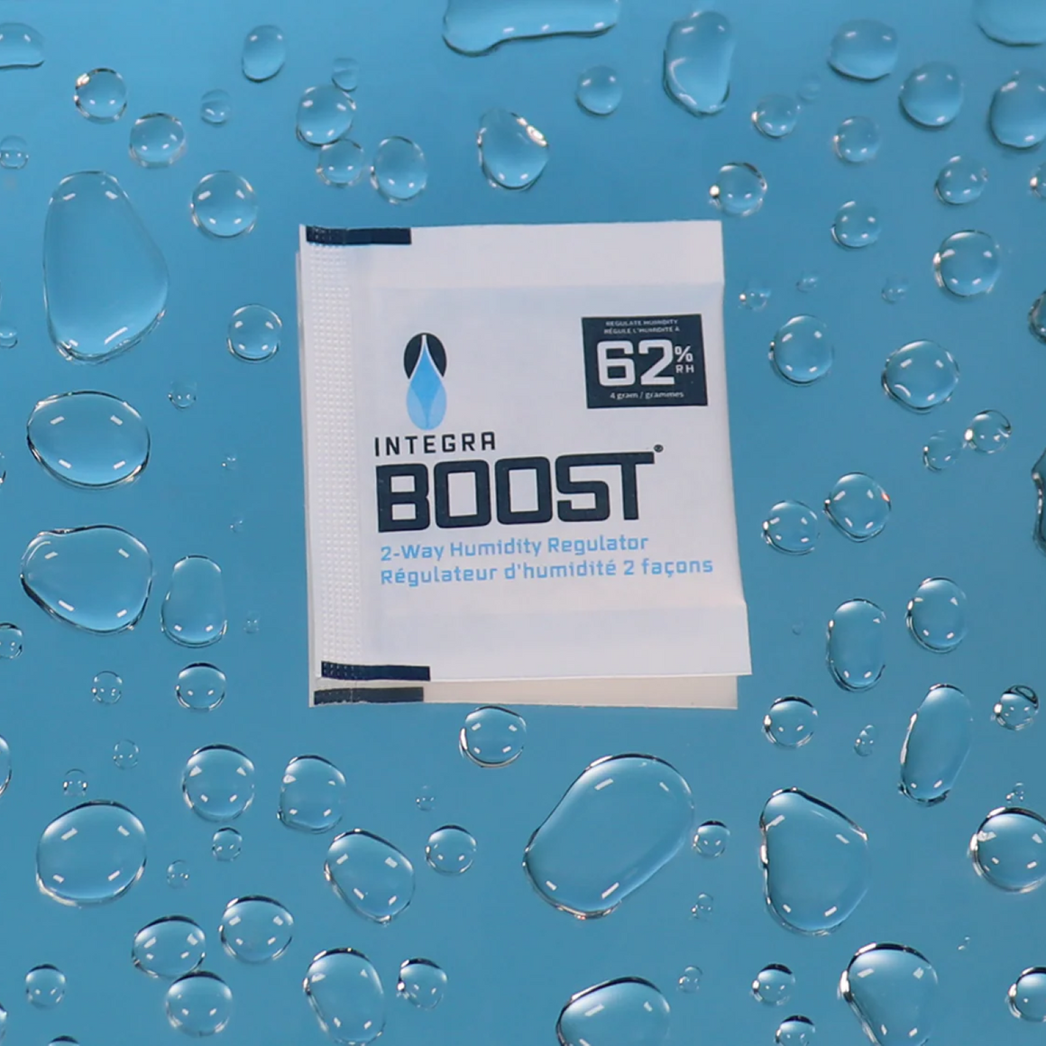 Close-up of a "Integra Boost" 62% humidity control packet surrounded by water droplets.