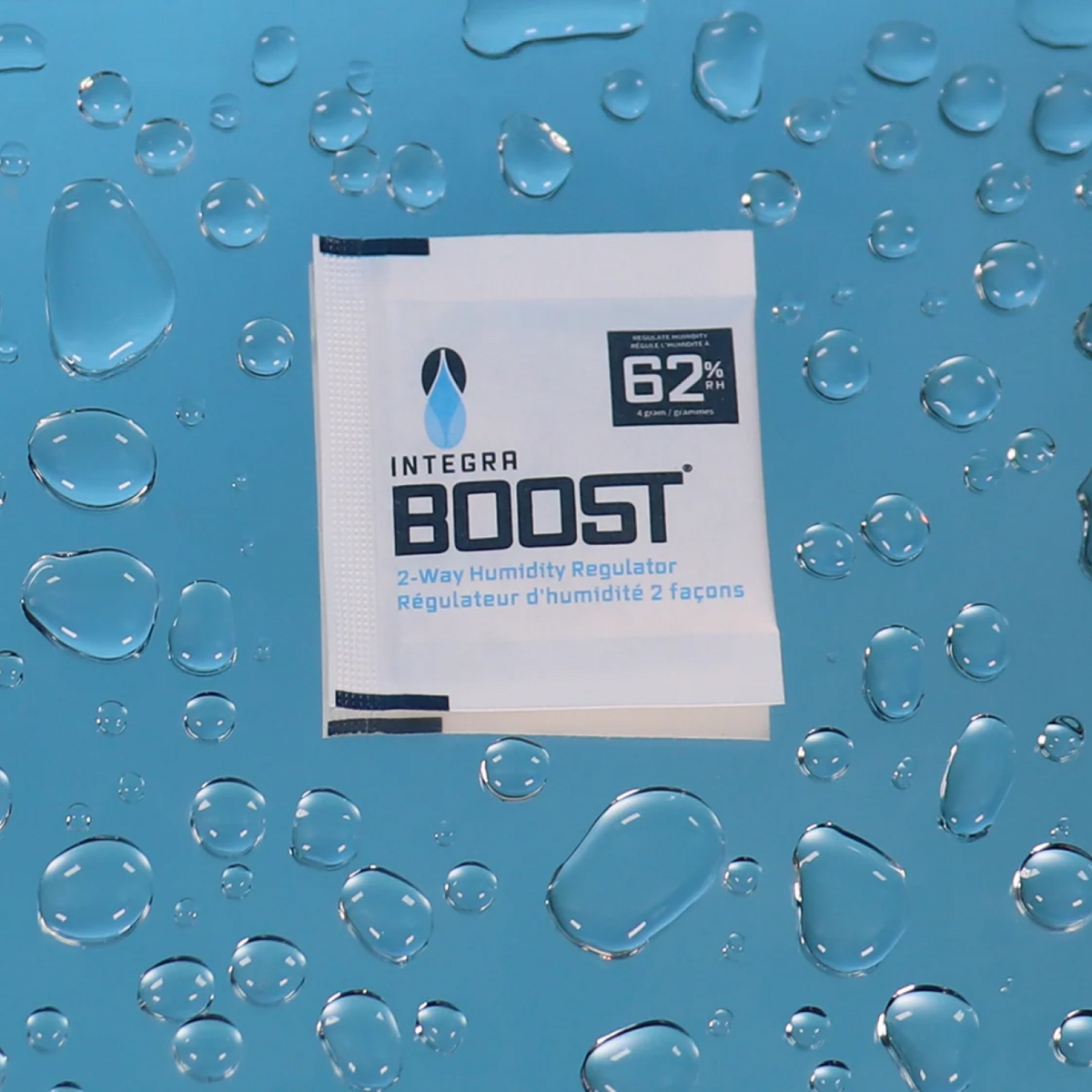Close-up of a "Integra Boost" 62% humidity control packet surrounded by water droplets.