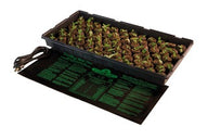 A seedling tray with many small plants sits on a black seedling heat mat with instructions.