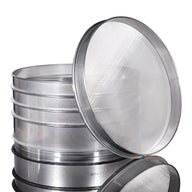 Stack of stainless steel sieves with fine mesh screens, some labeled 