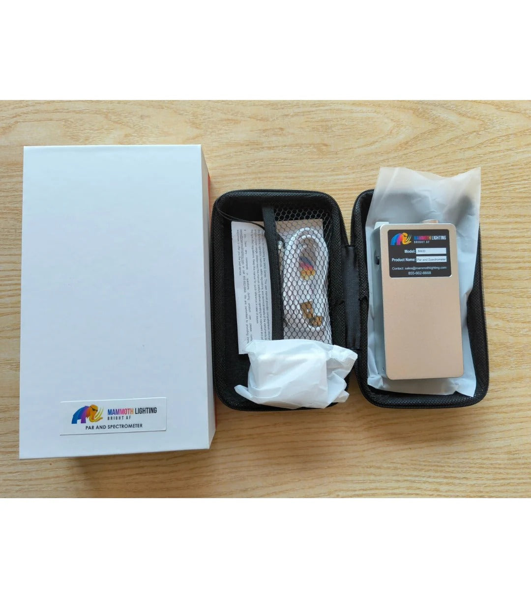 Mammoth Lighting PAR and Spectrometer kit, including box, case with device, and accessories, on a wooden table.