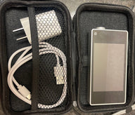 A black zipper case holds a silver digital device and white charging cables.