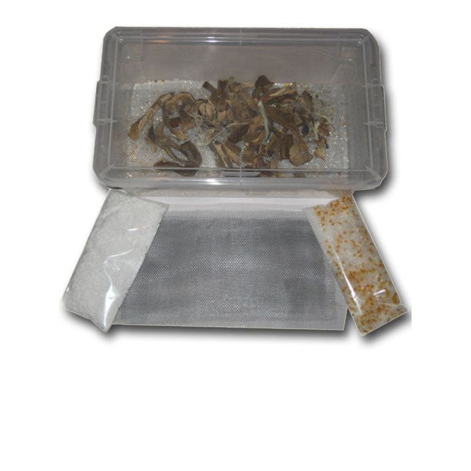 Mushroom drying kit: clear container with dried mushrooms, grey mesh mat, white & orange desiccant bags.