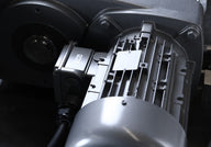 Close-up of industrial shredder motor with ribbed housing and electrical box.