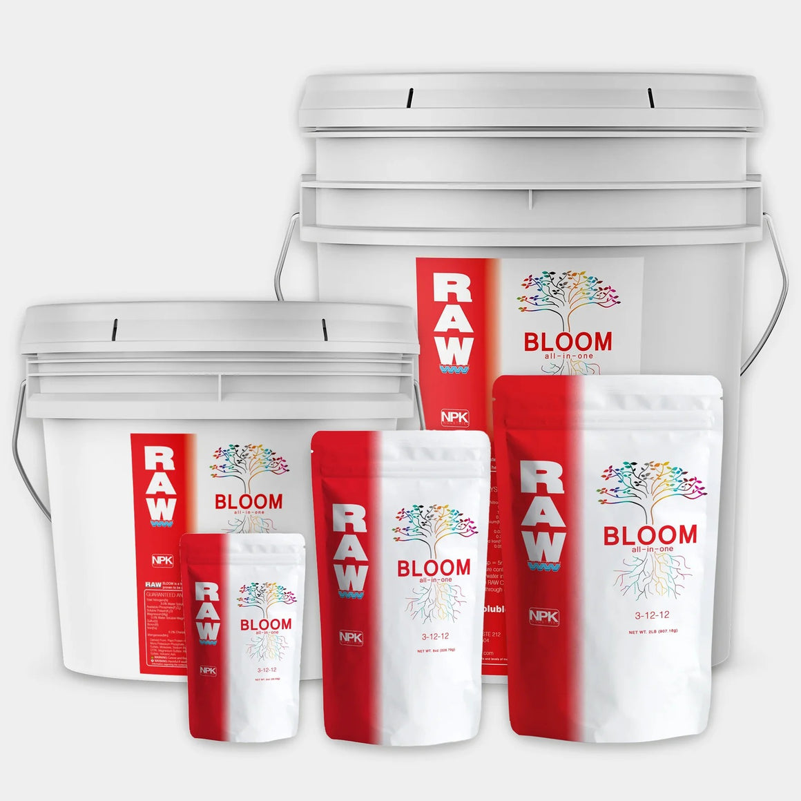 White buckets and bags of "RAW BLOOM all-in-one" fertilizer with rainbow tree logo and NPK 3-12-12.