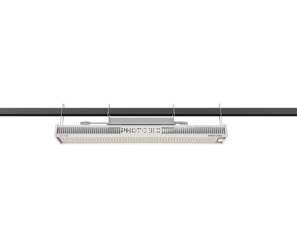 PHOTOBIO TX2 800W LED grow light suspended from a black bar.