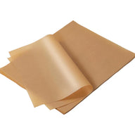 Brown unbleached parchment baking paper sheets stacked and fanned open on a white background.