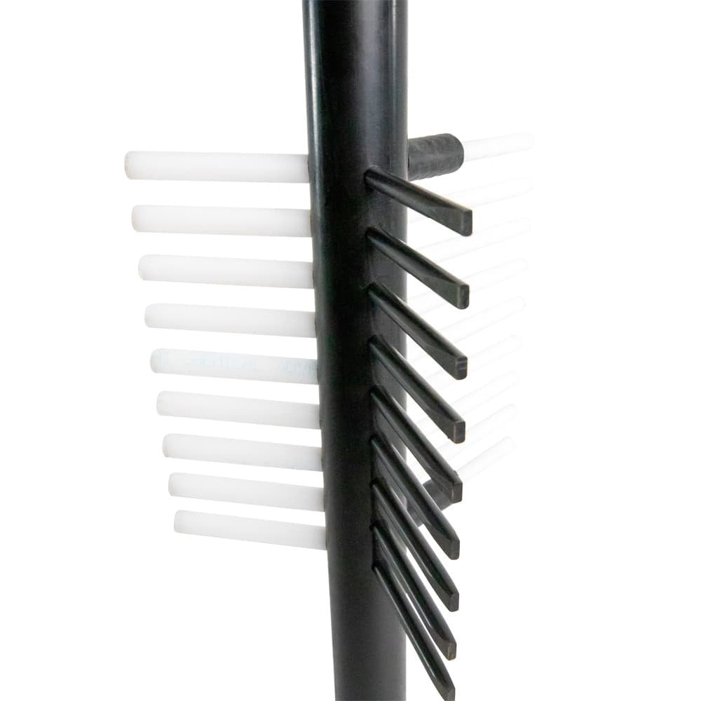 Close-up of white and black bristles on a cylindrical black object, isolated on white.