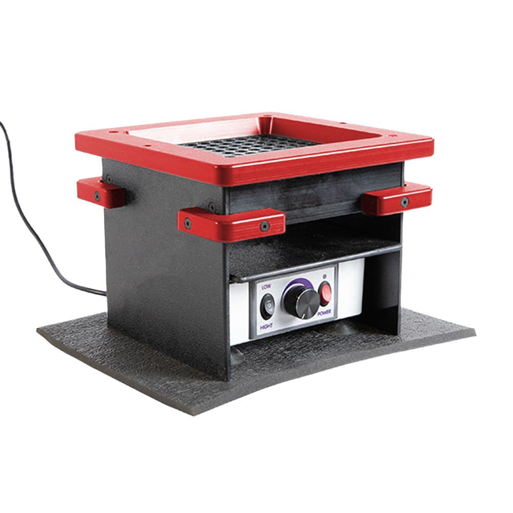 Square black vacuum forming machine with red trim and controls, on a textured base.
