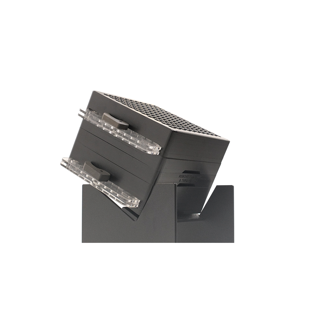 Black cone loading tool with clear clips and a honeycomb-textured top, angled on a dark gray stand.