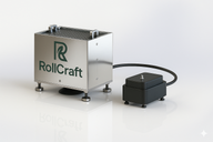 Shiny metal RollCraft machine with green logo, connected to black device.