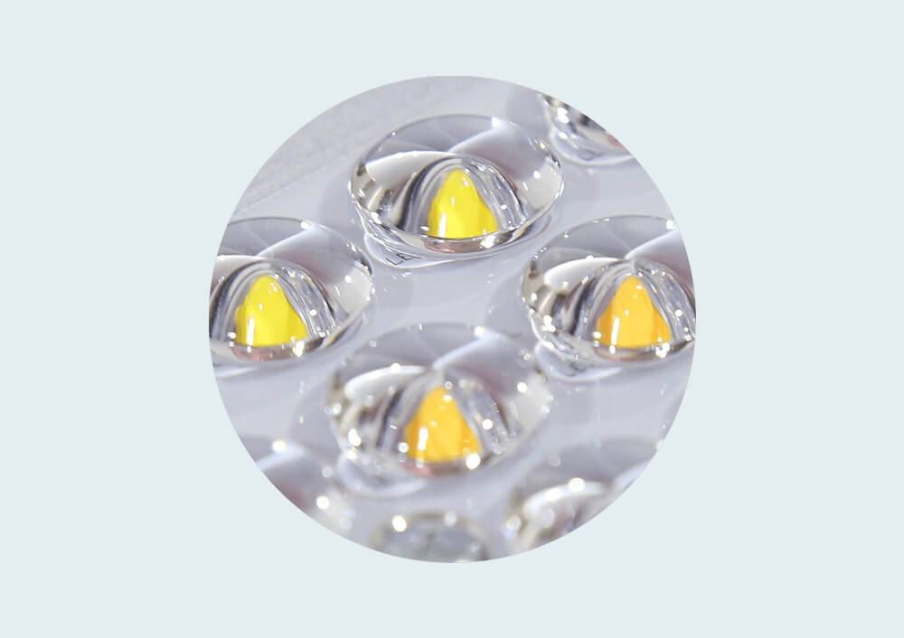 Close-up of yellow LEDs with clear plastic lenses in a grow light panel.