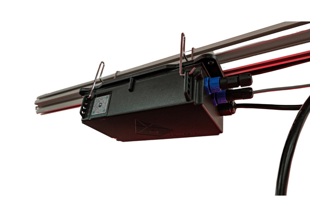 Black LED grow light box with blue connectors on a metal rail.