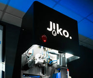 Jiko Plus 3D printer with white logo, red emergency stop button, and internal robotic arm.