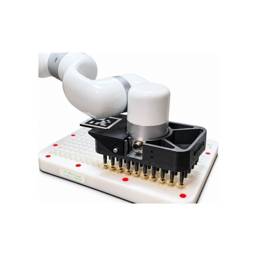 Robot arm holding a gripper with probes over a tray of small cones.