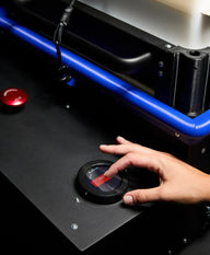 A hand presses a red 