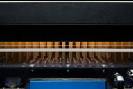 Robotic arm with pipette tips sorting vials in a lab.