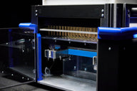 Close-up of a robotic filling and packaging machine for cannabis pre-rolls.