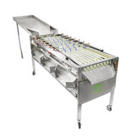 A Tom's Automatic Bud Sorting Machine with stainless steel construction, rolling wheels, and a wide sorting tray.