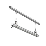 Silver linear LED grow light fixture with visible LEDs, suspended by wires from a metal rod on a white background.