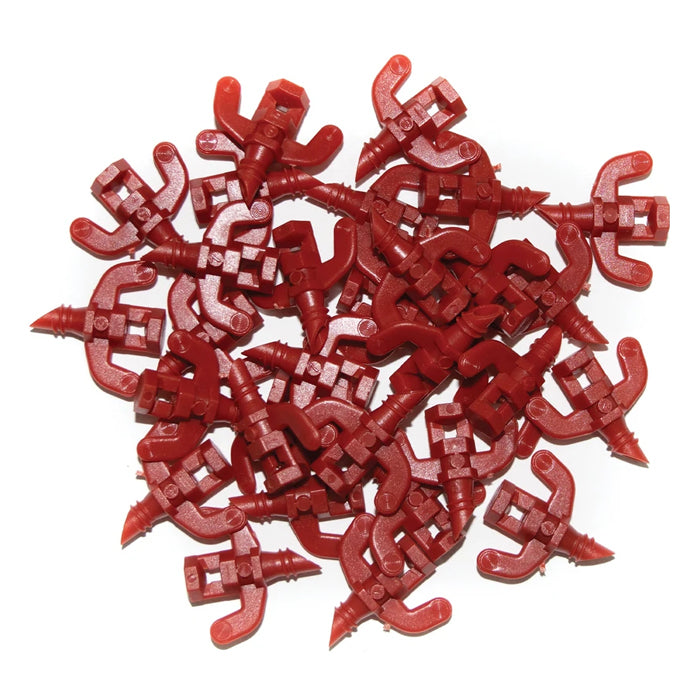Pile of red plastic cloner spray jets, for hydroponics, white background.