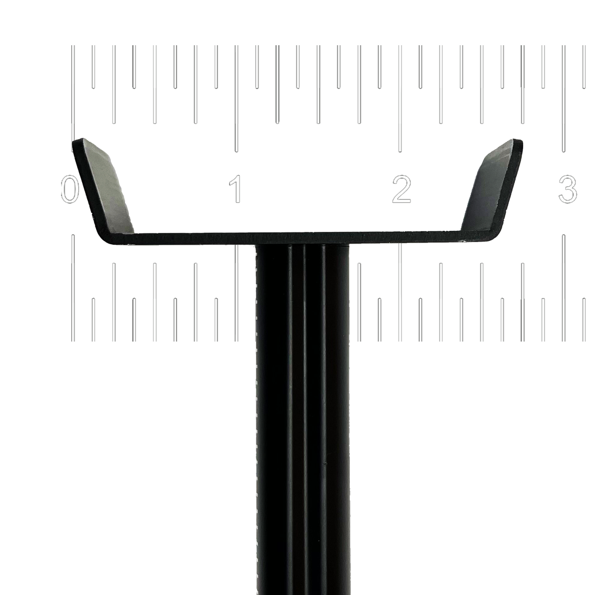 Black metal under-canopy light stand with upturned ends, displayed against a ruler for scale.