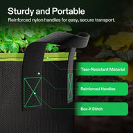 Close-up of a black fabric grow bag with green trim, showing reinforced handles and 