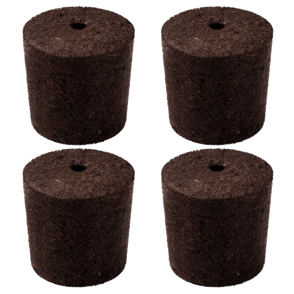 Four brown peat moss seed starters with holes in the center, arranged in a 2x2 grid against a black background.