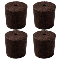 Four brown peat moss seed starters with holes in the center, arranged in a 2x2 grid against a black background.