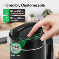 A finger presses the start button on a black Vivosun herbal extraction machine with green accents.