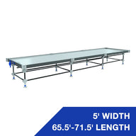 Adjustable 5' W x 65.5'-71.5' L rolling bench with metal trays and blue height adjusters.