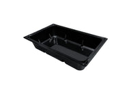Black plastic reservoir tray with raised compartments and smooth sides, isolated on white background.