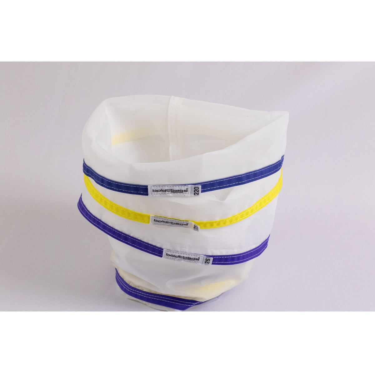 White mesh bags with blue and yellow trim, stacked.