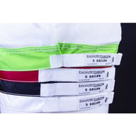 Stacked boldtbags 5-gallon mesh bags in green, red, black, and white with white labels.