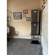 Cannatrol C2 drying and curing system with digital display in a room with fishing-themed decor.