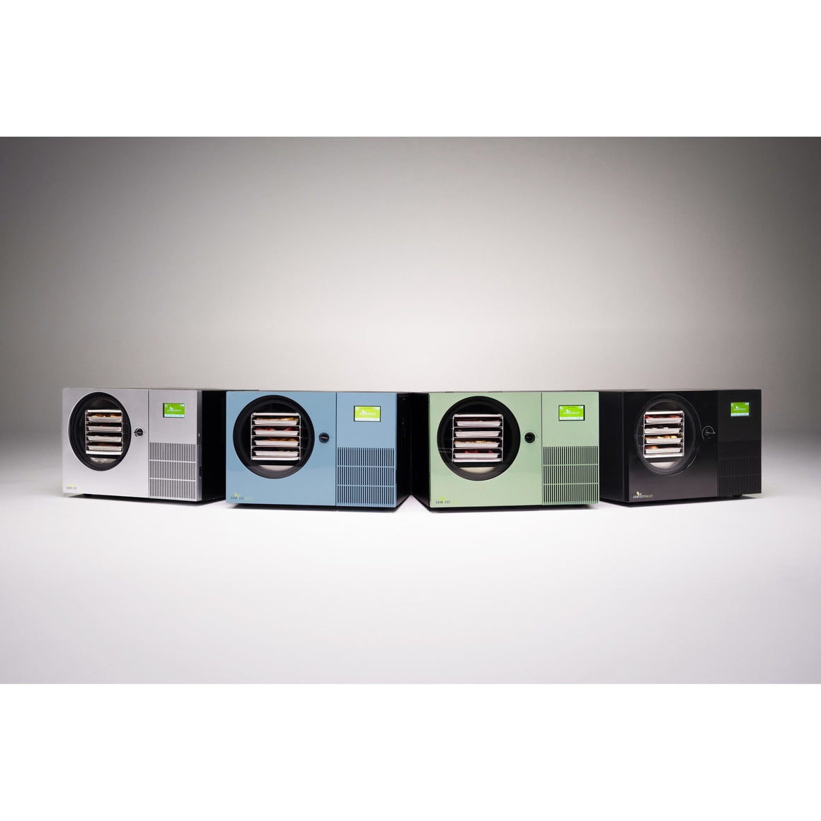 Four Harvest Right Countertop 360 freeze dryers in stainless steel, pale blue, sage green and black, side by side