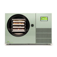 Sage green Harvest Right Countertop 360 freeze dryer, front view with four loaded trays behind the round door