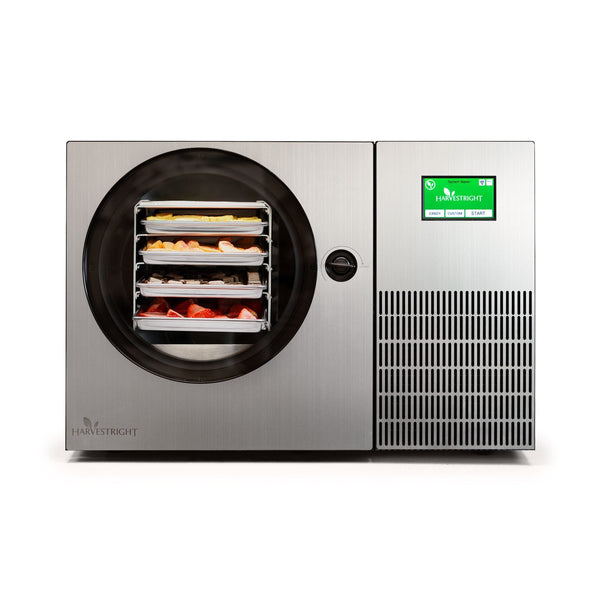 Harvest Right freeze dryer with food trays and touchscreen display.
