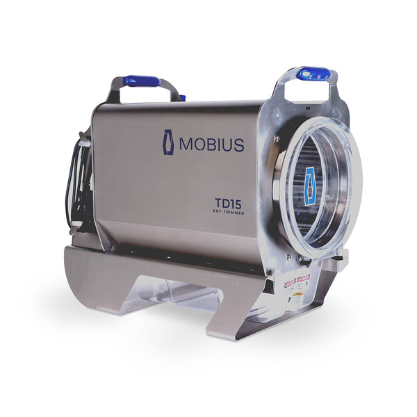 Mobius TD15 Dry Trimmer: sleek silver industrial processing machine with blue handles and a clear chamber.