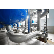 Industrial piping system with a large blue tank, metal pipes, and valves.