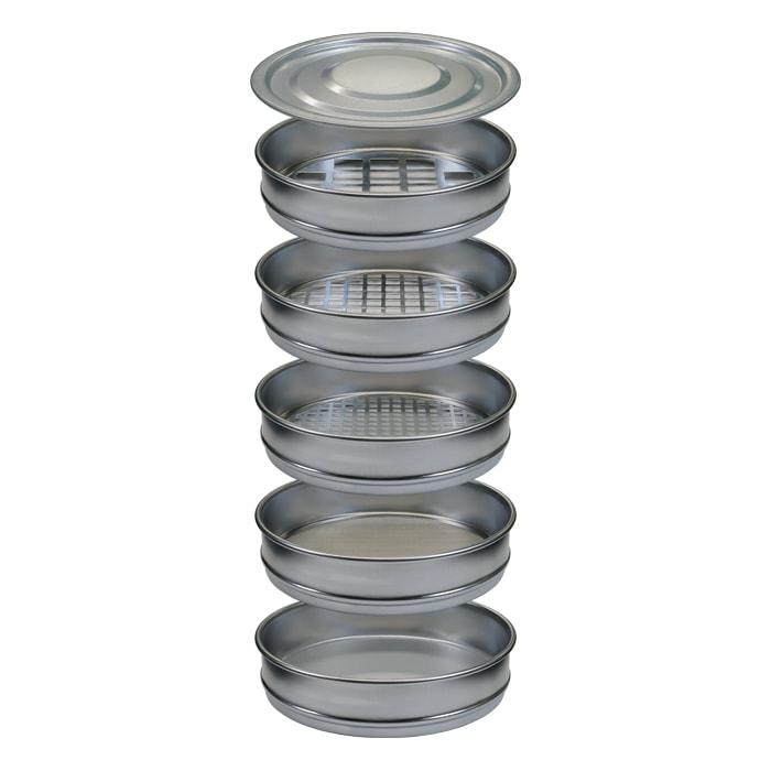 Stack of metal sieves with mesh screens and a lid, used for sorting.