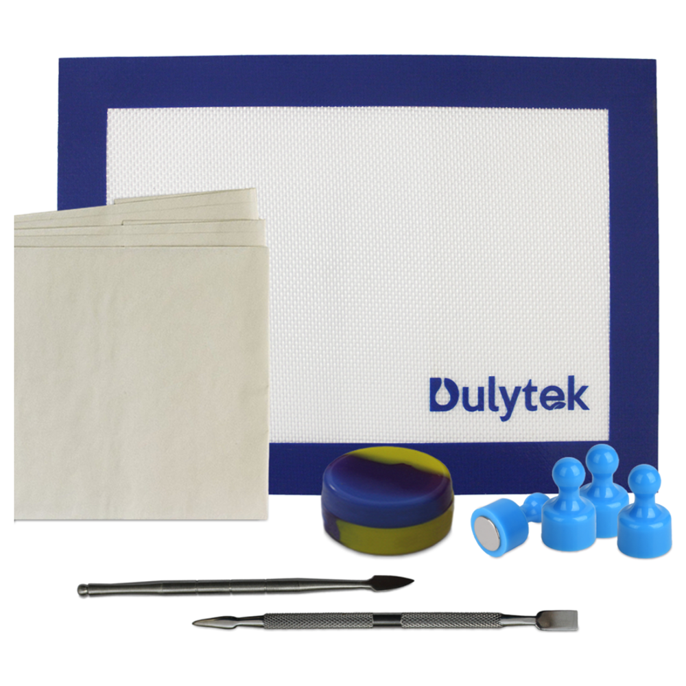 Dulytek rosin press starter kit: blue and white mat, parchment paper, silicone container, tools, and magnets.