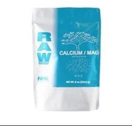 A white and blue bag of NPK RAW Calcium/Magnesium nutrients with a tree root design.