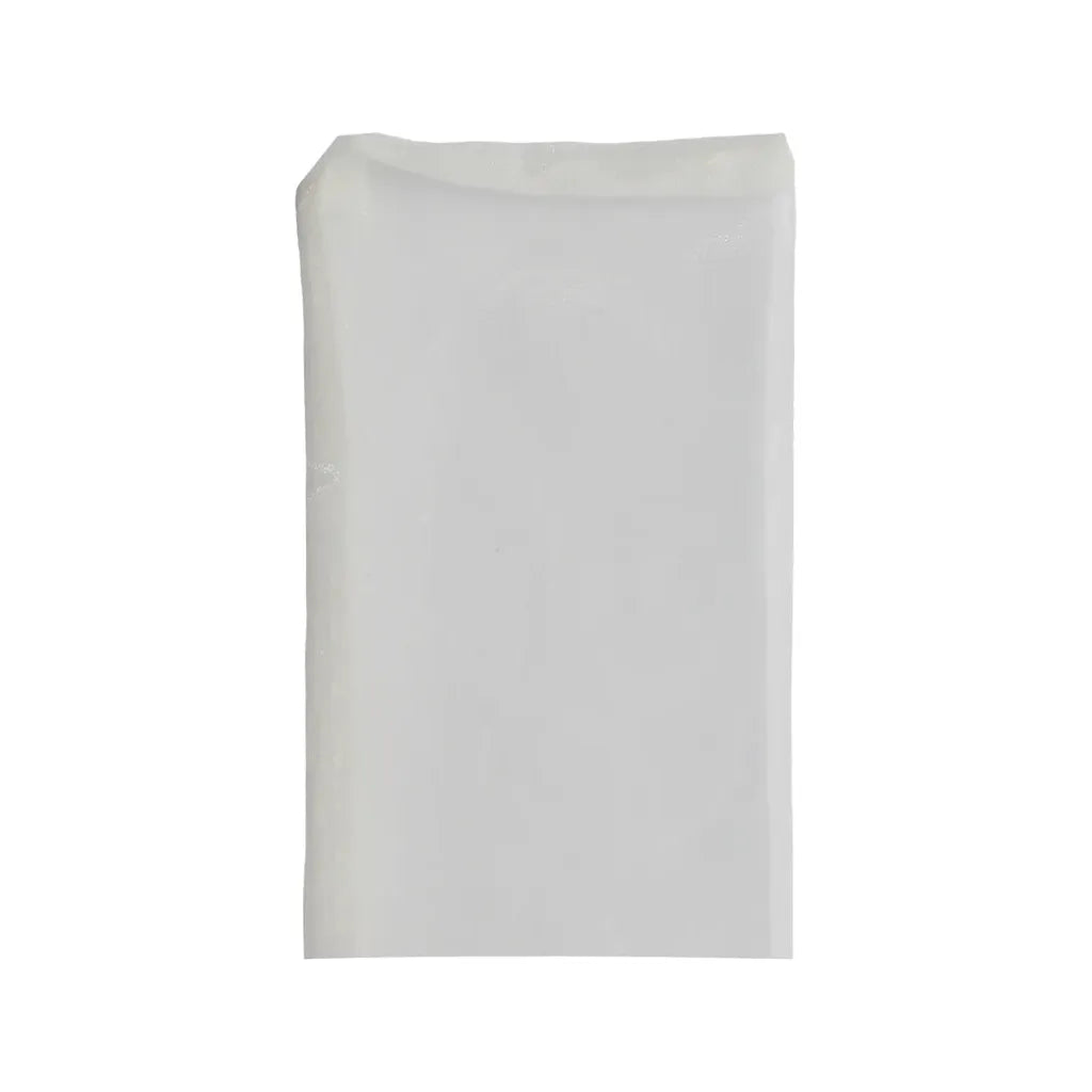 A single, translucent white filter bag lies flat on a white background.